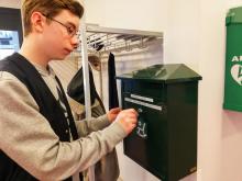 poika laittaa kirjeen postilaatikkoon